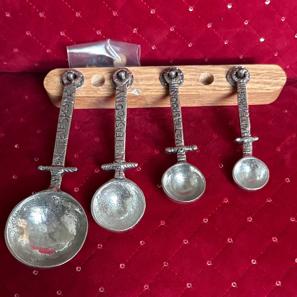 Silver Measuring Spoons Set on Wooden Rack